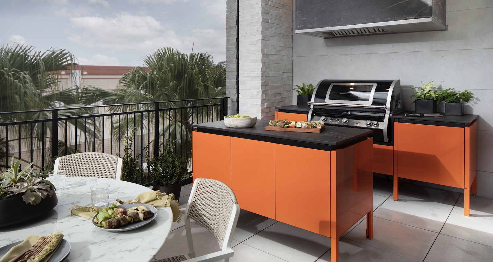 Brown Jordan outdoor kitchen cabinets in bright orange for The New American Home 2021