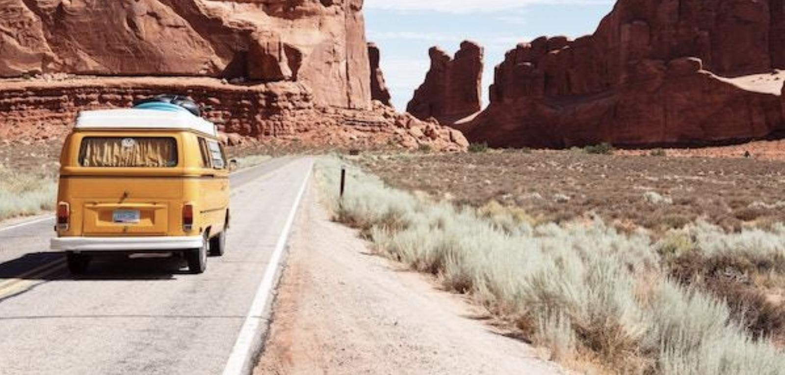 Volkswagen van on desert canyon road. 