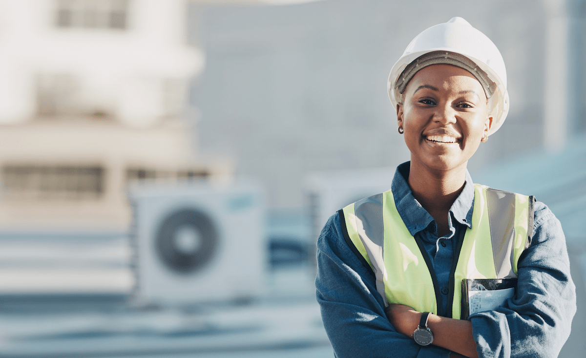 Woman construction worker wearing white hard hat on jobsite