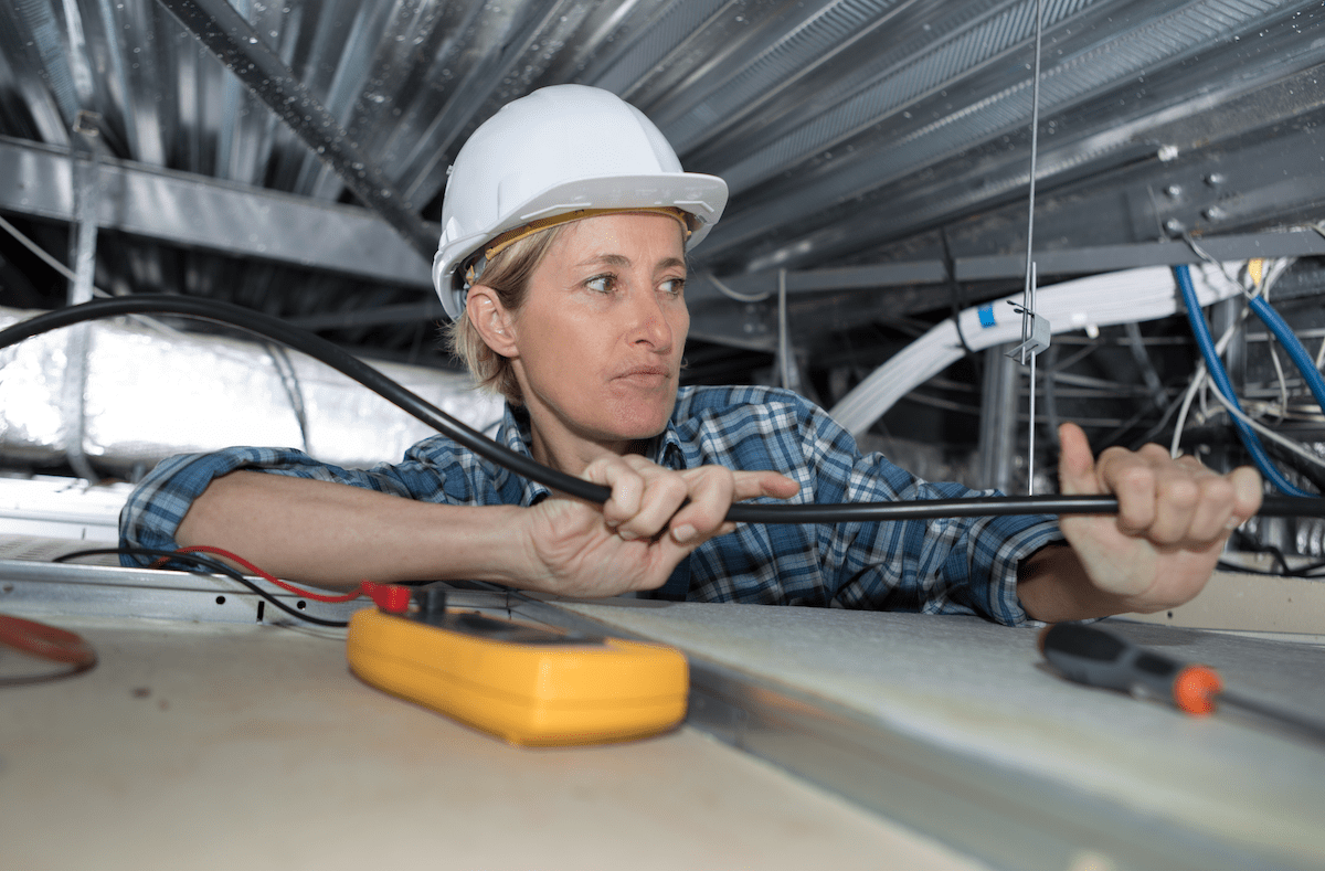 Woman electrician at work on jobsite