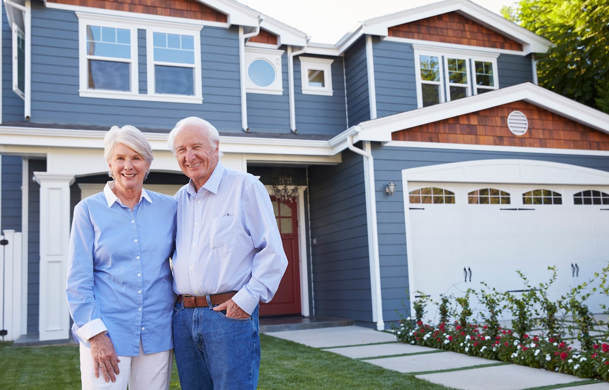 Baby Boomer homebuyers outside their new house