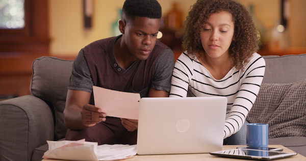 Black couple looking at homes online