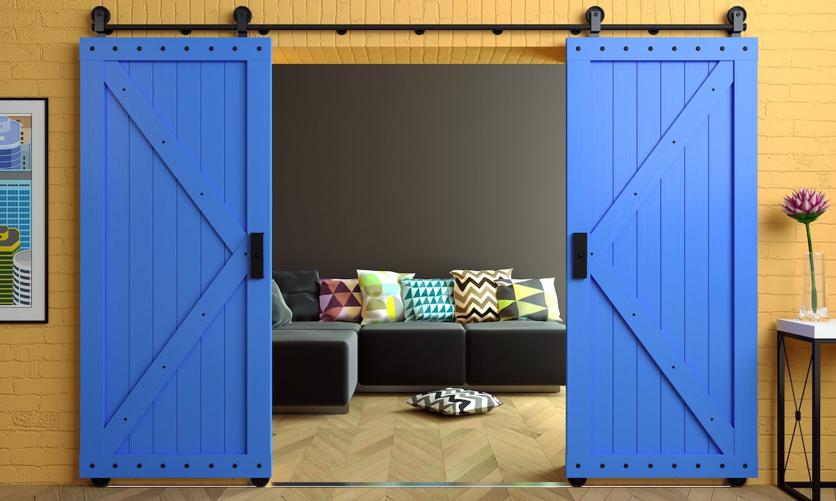 Bright blue barn doors in home loft