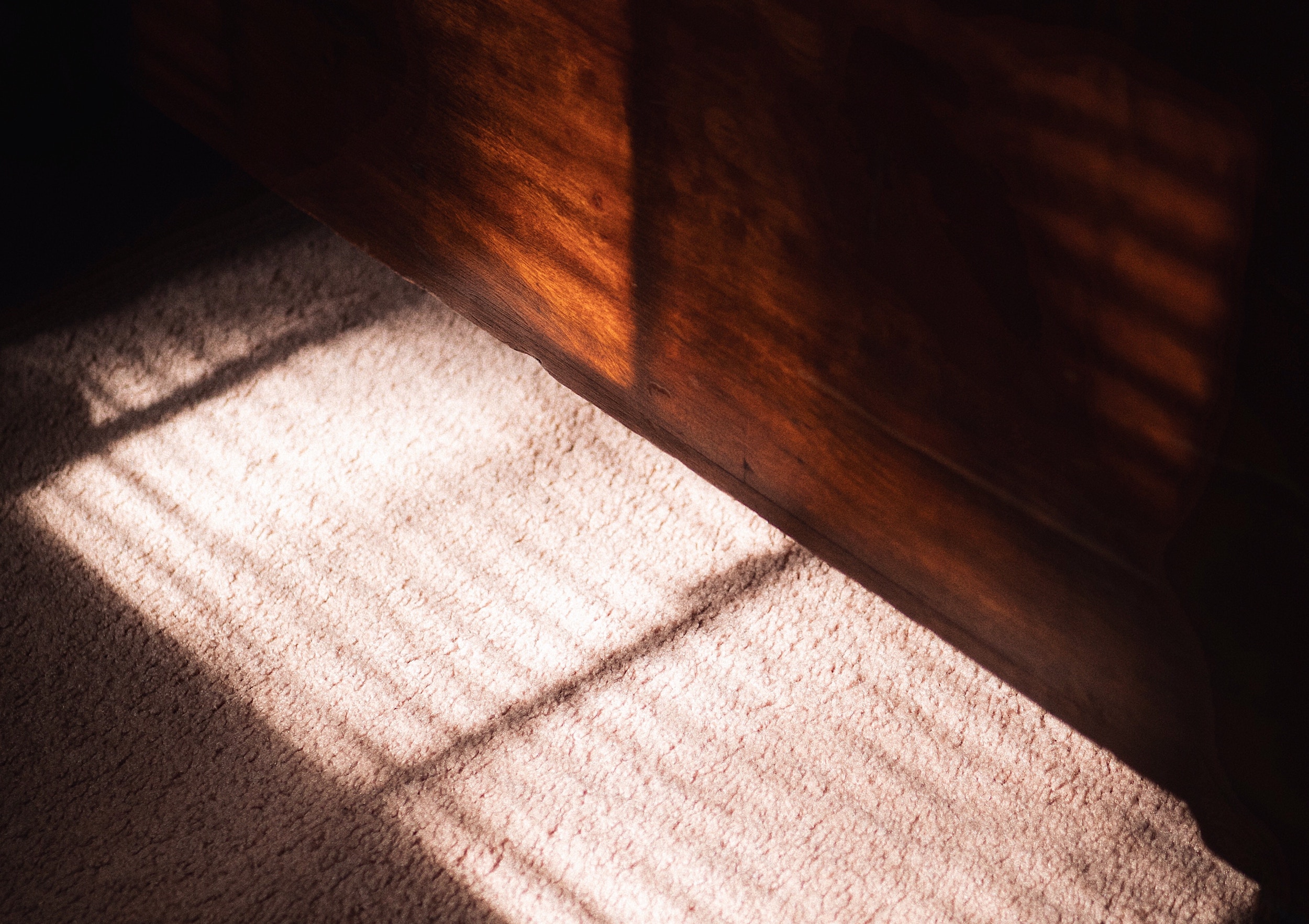 Light coming in through window showing on carpeted floor