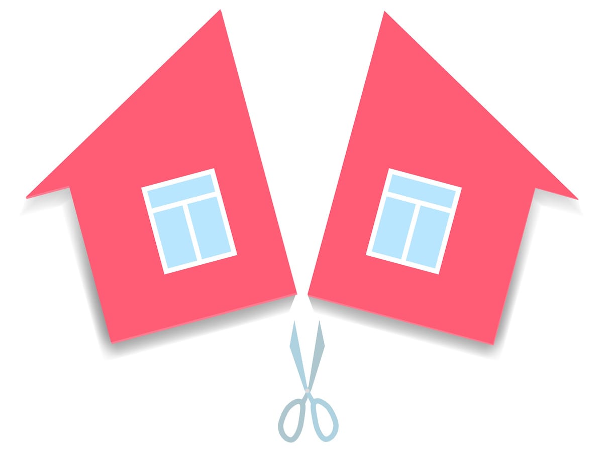Red house graphic split in two by pair of scissors