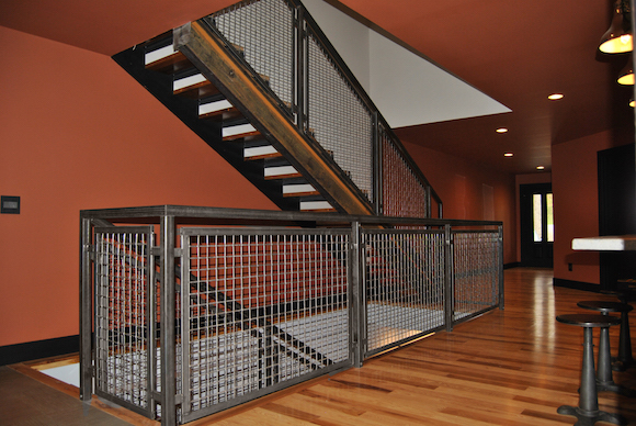 The woven wire mesh of this stair railing was fabricated into panels and installed on site to fit with the home’s rustic-modern aesthetic.