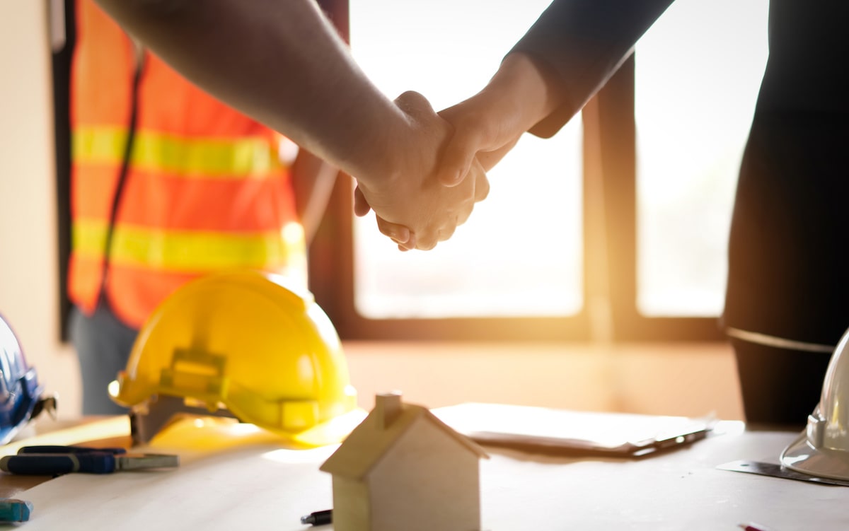 Builder and client shaking hands