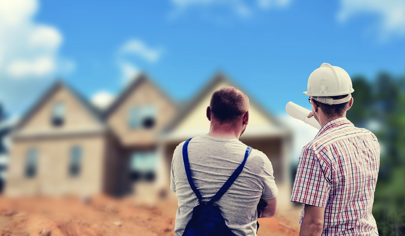 A home builder and subcontractor assess construction quality on jobsite  