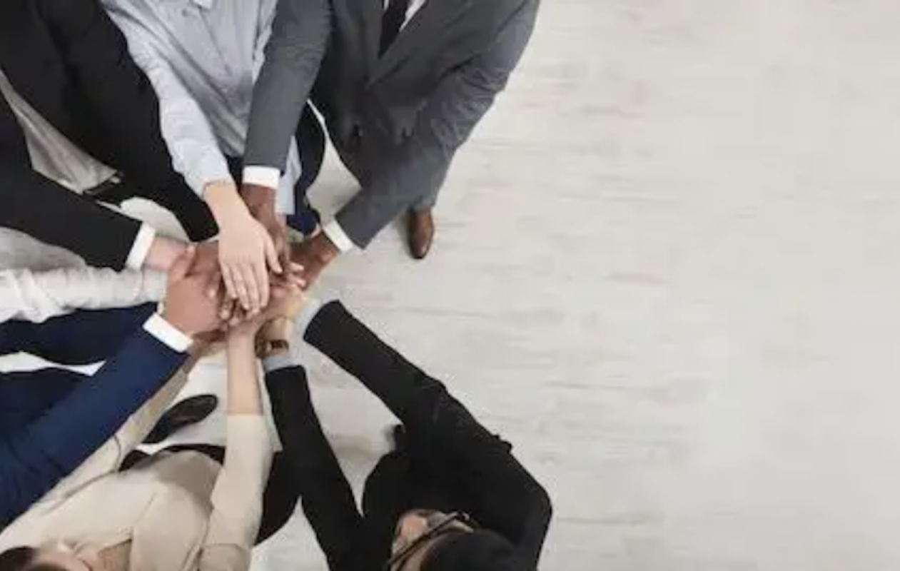 people with hands in circle show corporate diversity and teamwork 