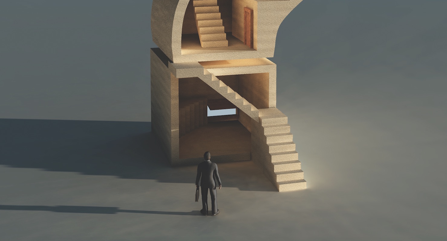 businessman looking at stairs leading to the future of his business as he plans for succession