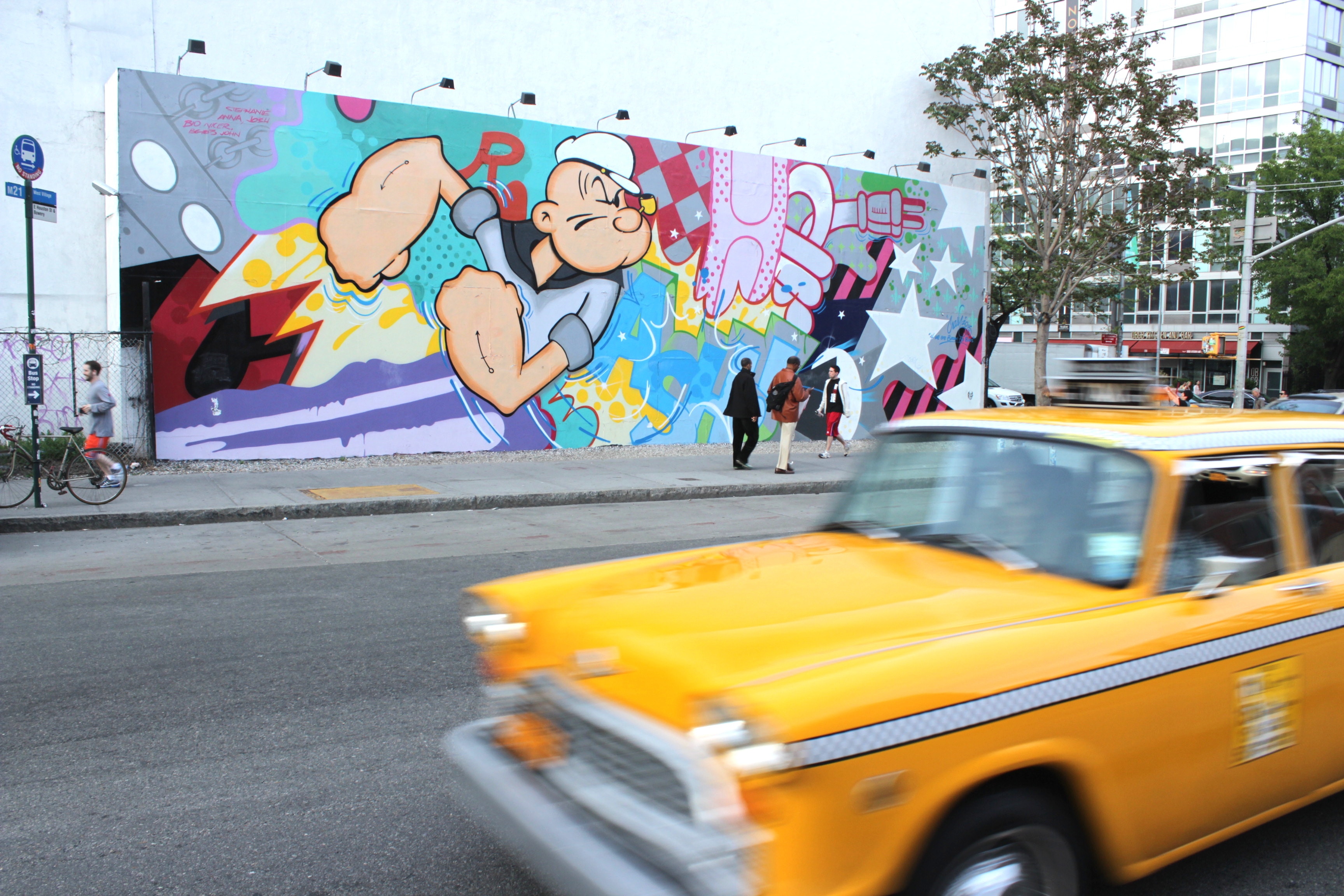 Checker cab in NYC in front of mural