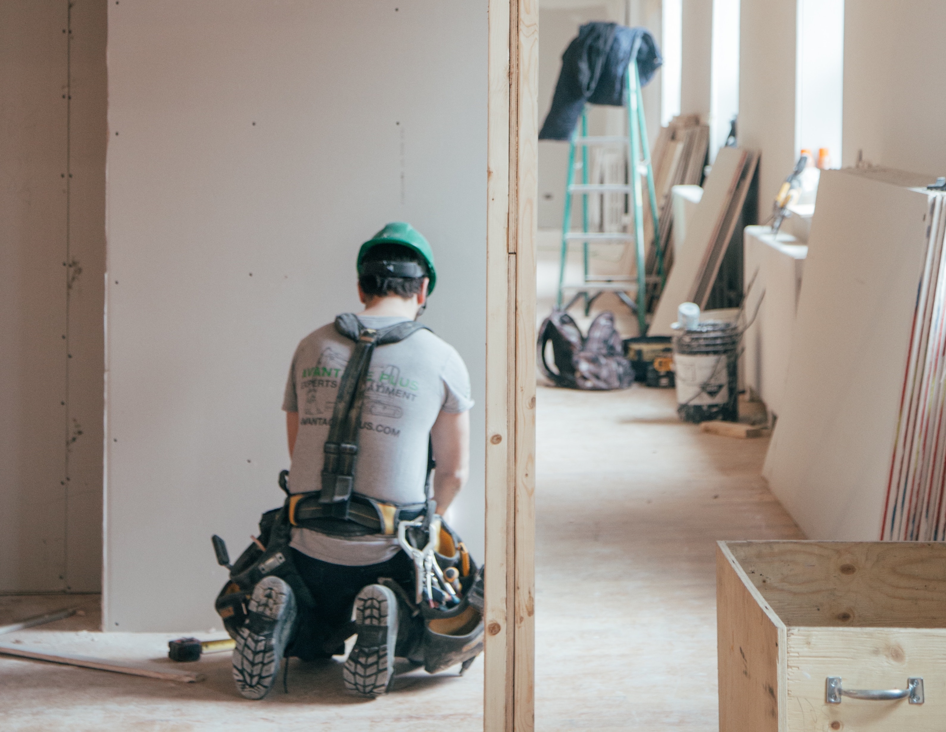 Construction worker at work on home interior installing drywall