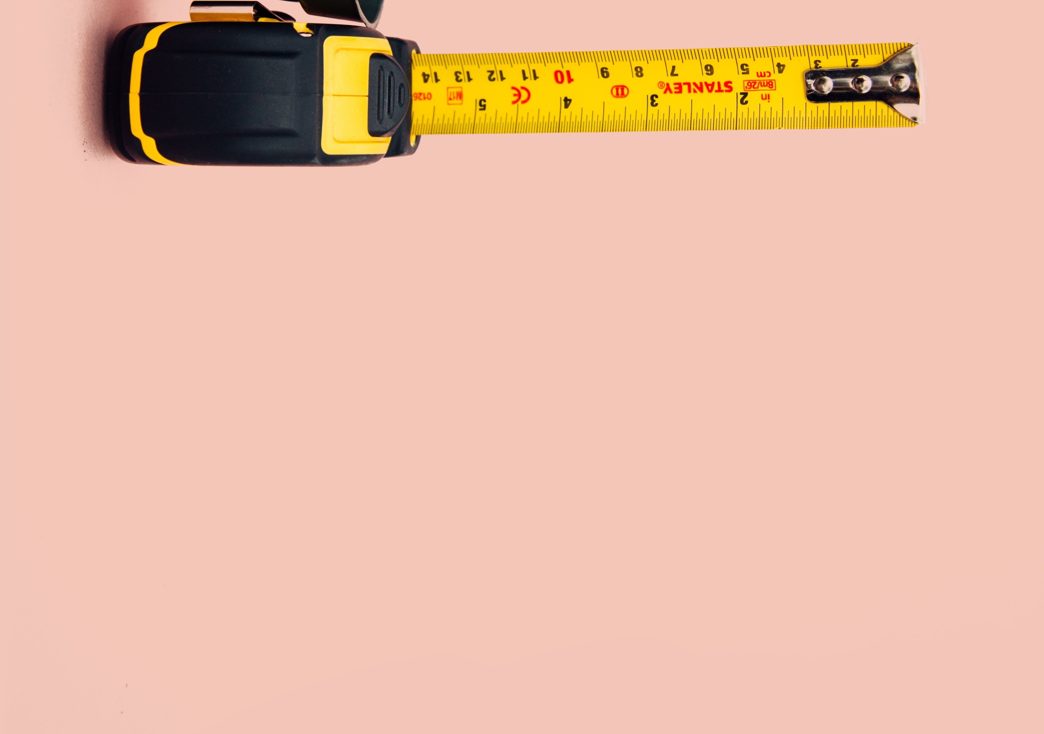 Tape measure on pink background