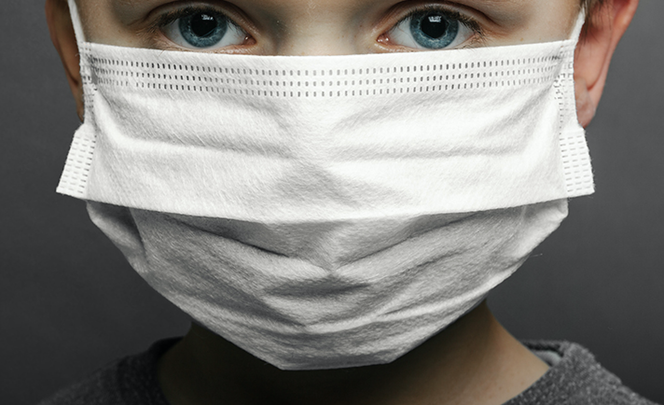 Child wearing protective mask against coronavirus