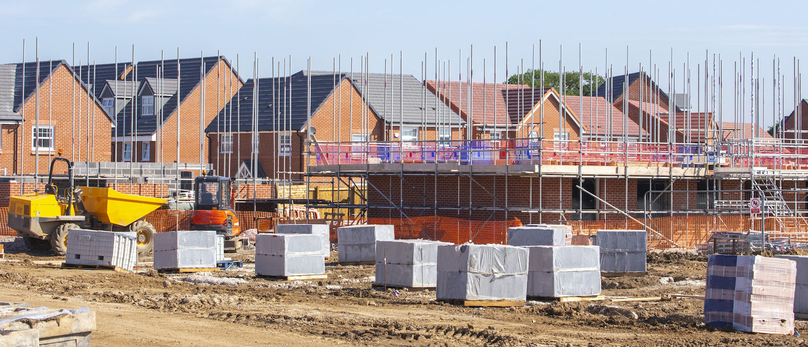 Construction site with houses under frame