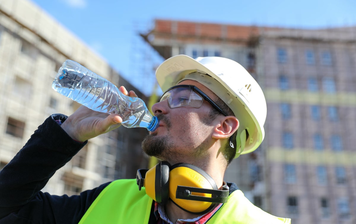 Construction worker drinking water