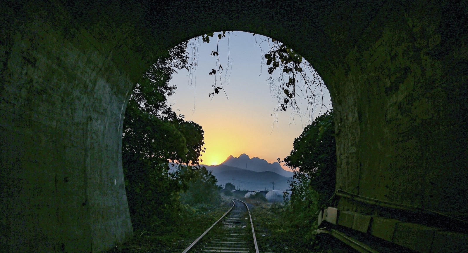 Daybreak at end of dark tunnel signaling a new beginning