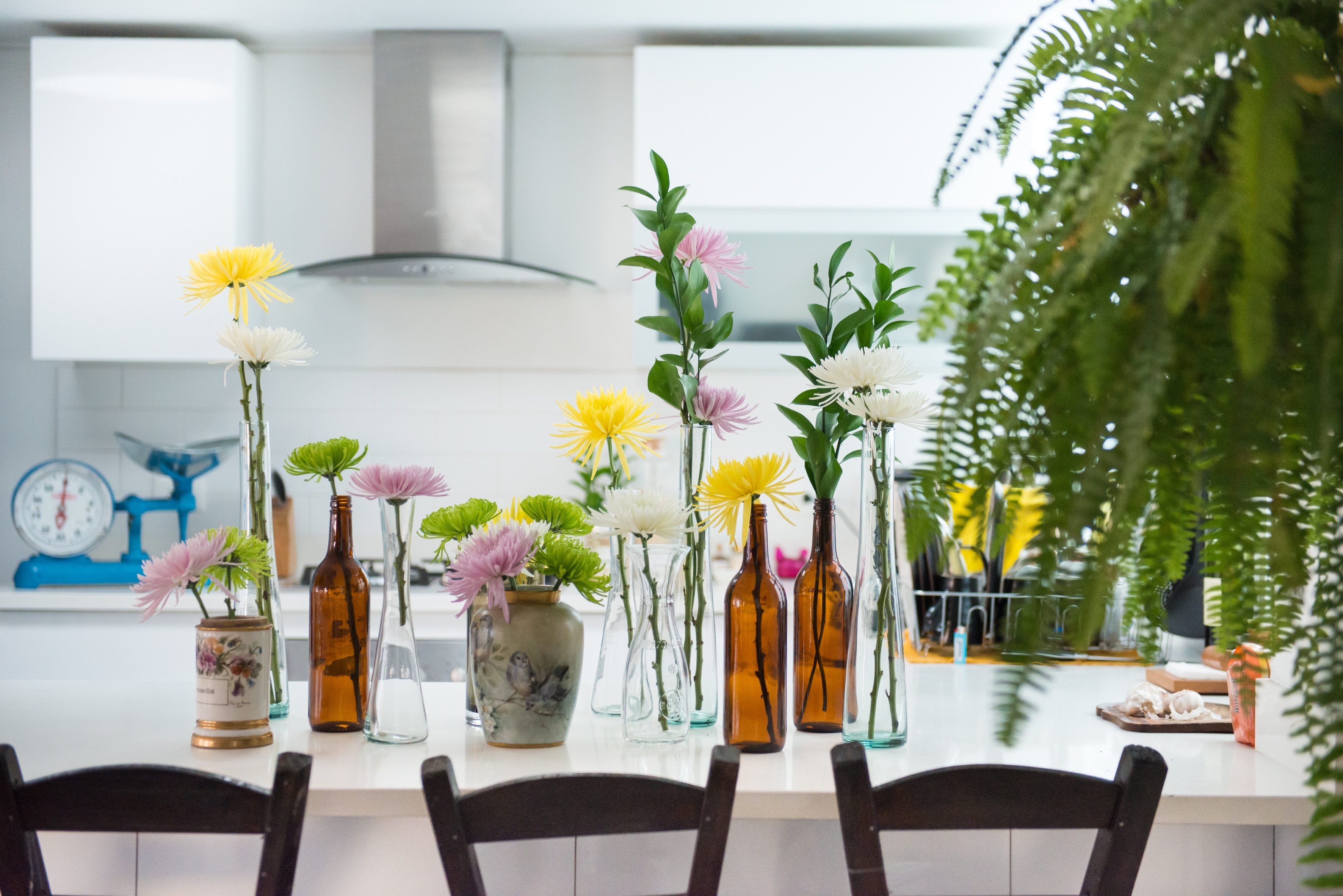 Kitchen with flowers in vases on table