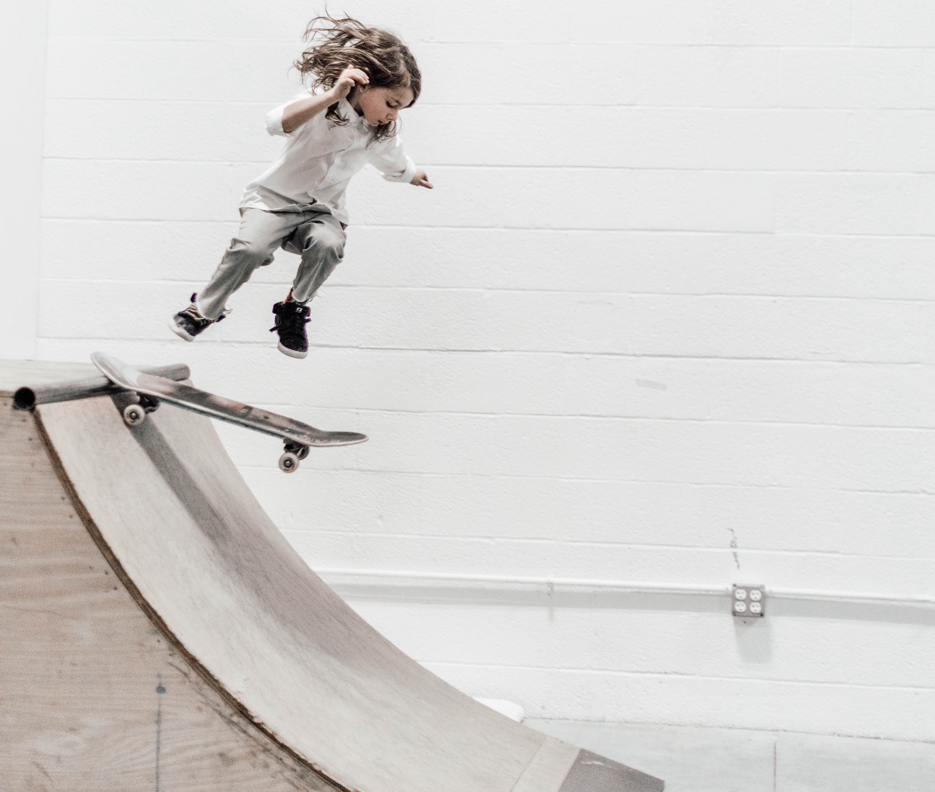 Child skateboarding down a ramp