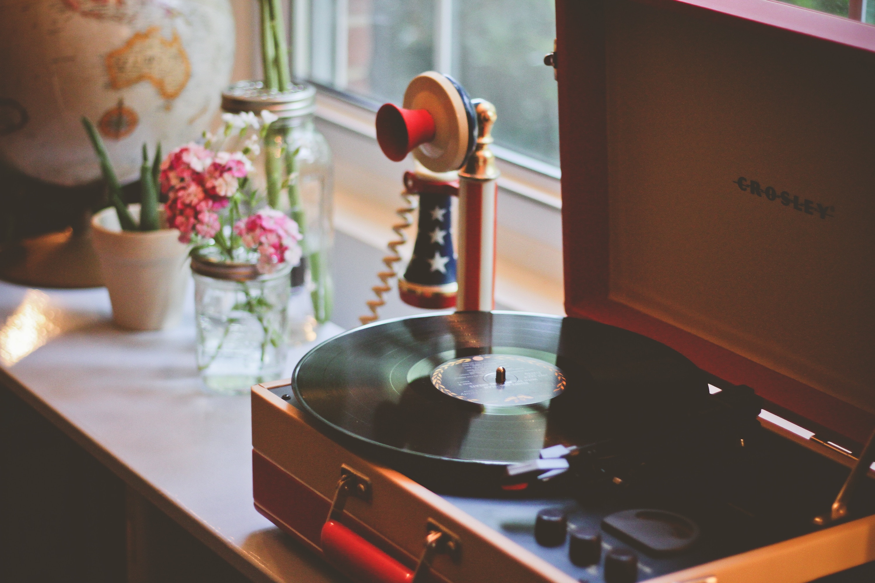Table with record player and red white and blue phone