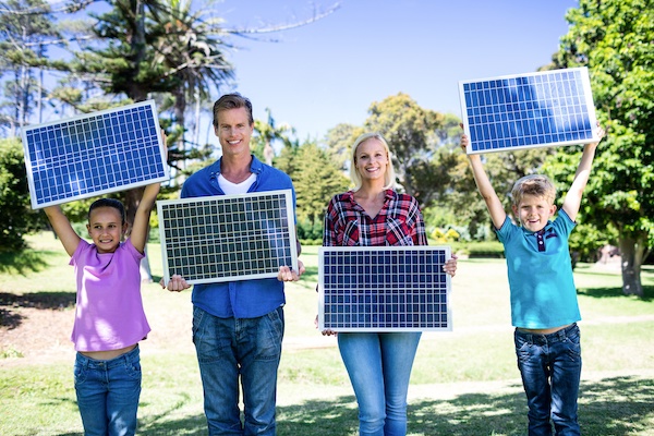 Family Holding Solar Panels