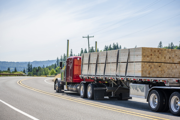 Flat-bed truck hauling lumber