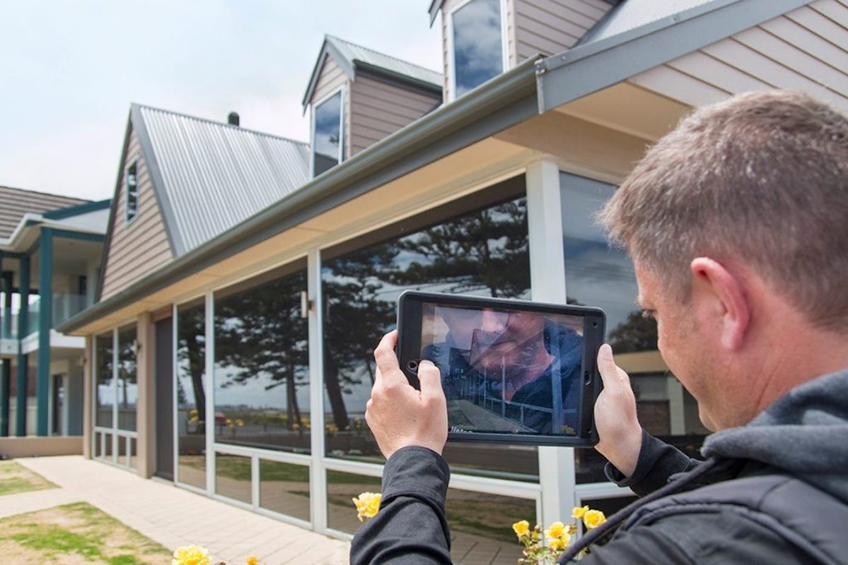 Home builder using a tablet for a virtual inspection