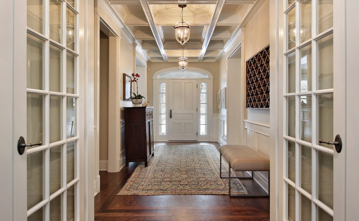 House foyer with glass french doors and bright accents 