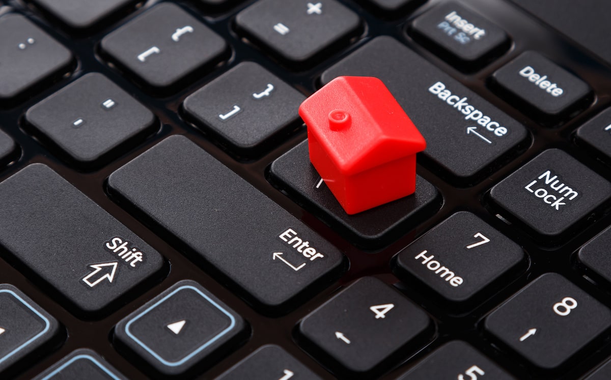 Red house model on computer keyboard