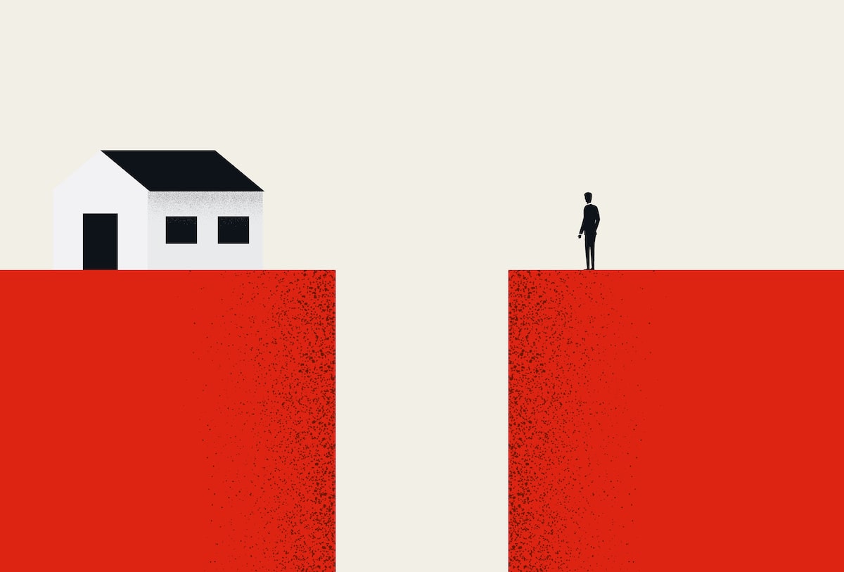 Person standing on red block overlooking home out of reach on opposite red block