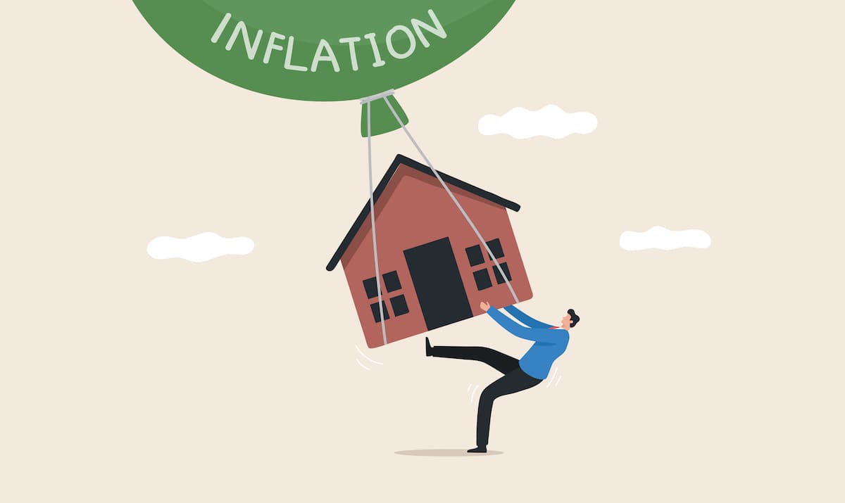Graphic of man holding onto home being lifted by green balloon labeled "inflation"