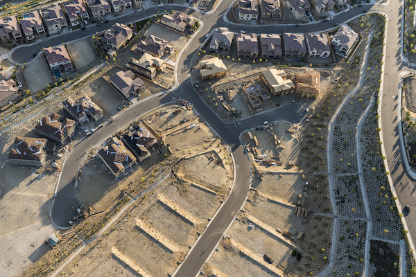 aerial view of housing development with some houses built and other empty lots ready for construction
