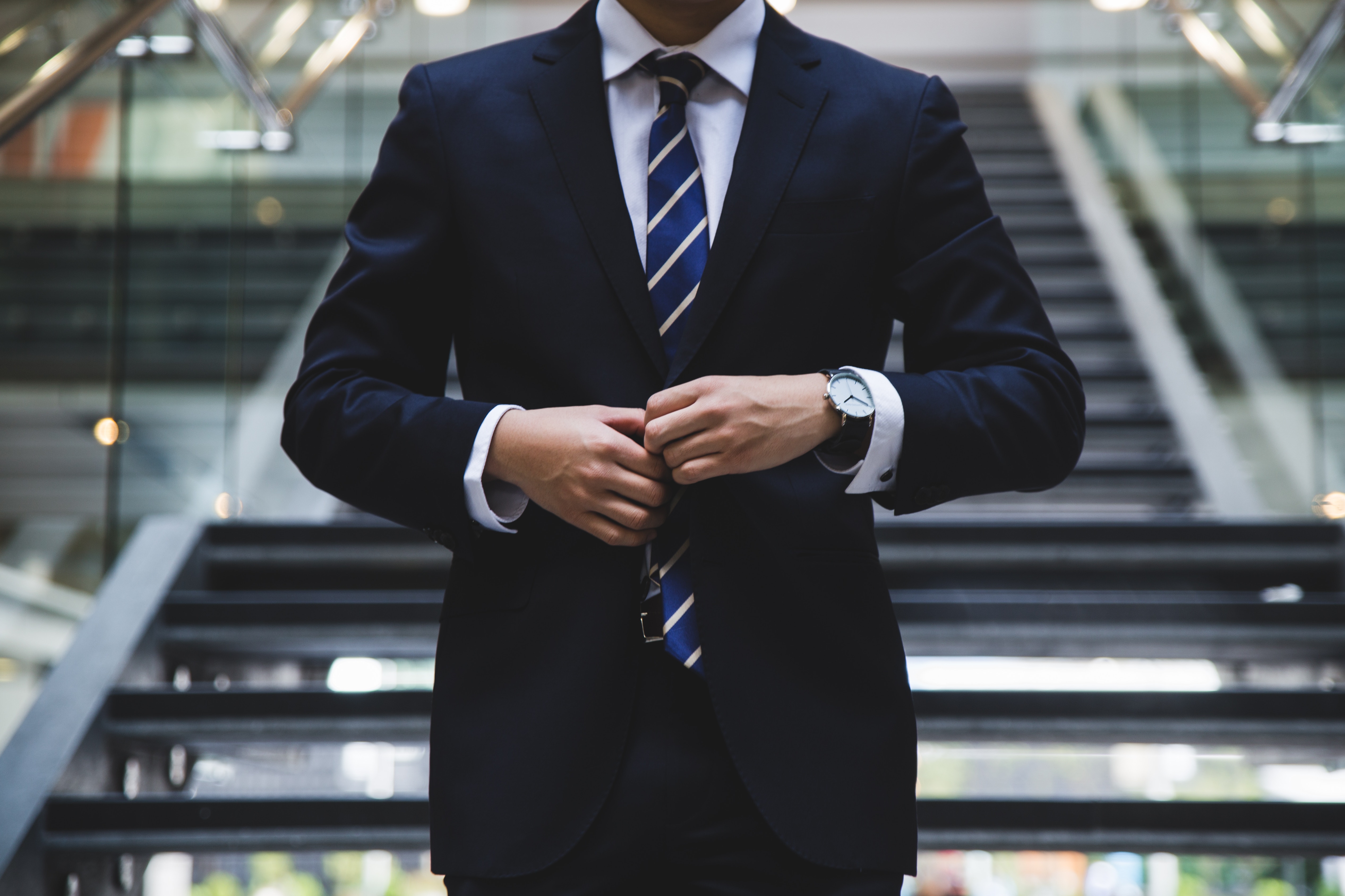 Man in business suit adjusting his tie