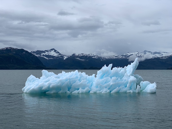 iceberg floating in water affected by climate change