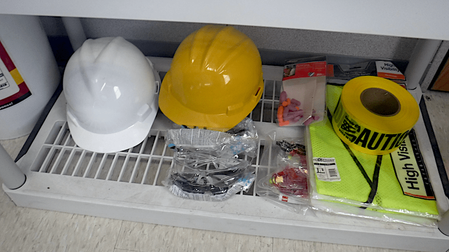 Construction PPE (personal protective equipment) on shelf in jobsite trailer