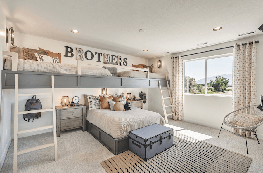 This kids' bedroom design accommodates multiple children and is an example of kid-friendly home design in action.