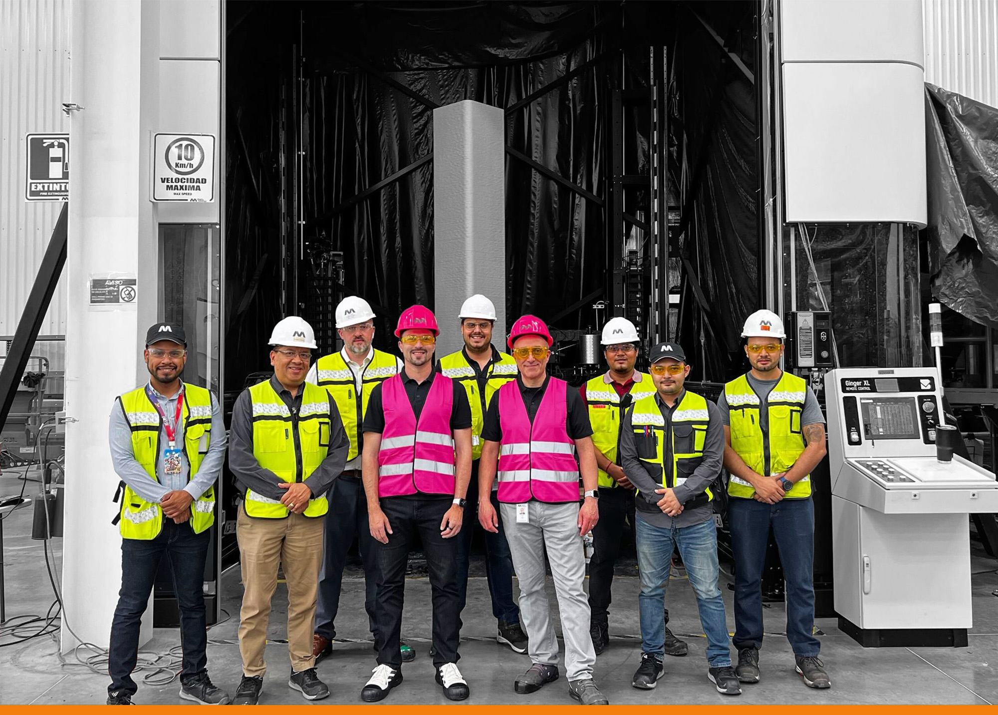 Construction people in front of 3D construction printer