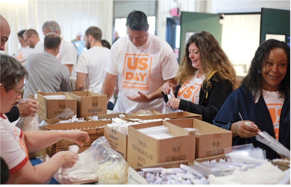 True Homes volunteers pack boxes for the homeless