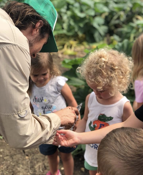 as part of Hillwood Communities' Live Smart campaign, farmers and kids plant seeds