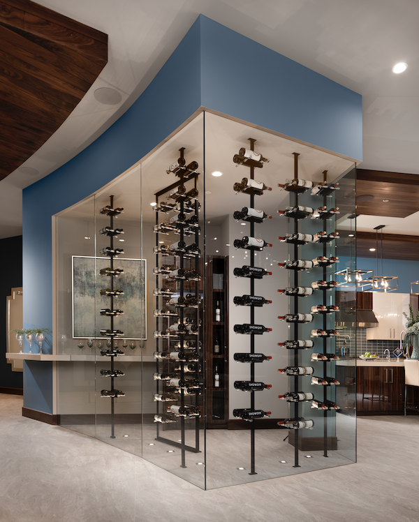 The New American Home dramatic glass display for wine storage adjoining the kitchen