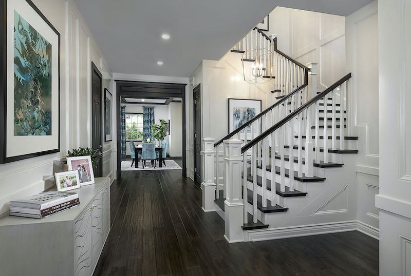 Open floor plan home design with winding staircase