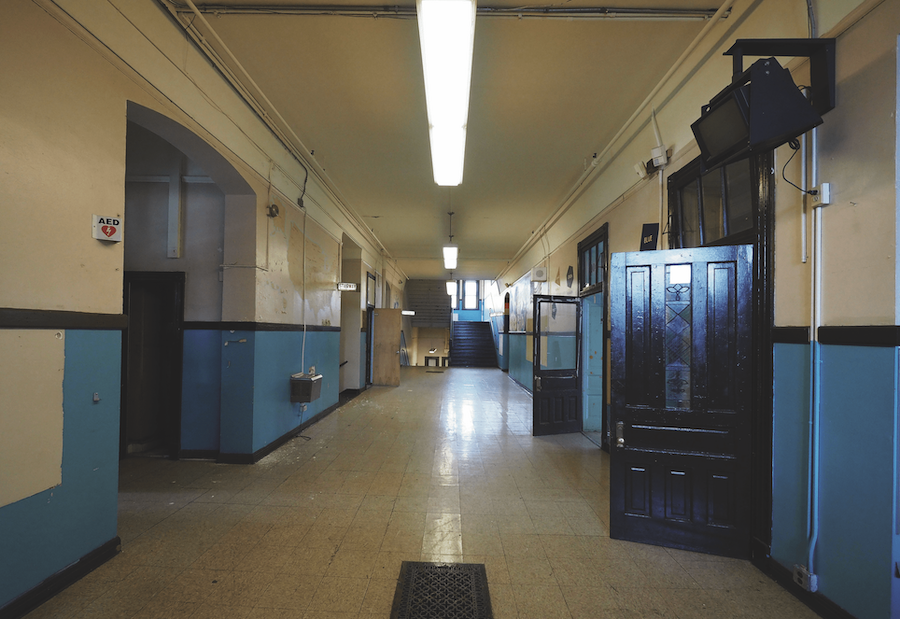 Before renovation view of a hallway in Peabody School Apartments, an adaptive reuse project and 2023 BALA winner
