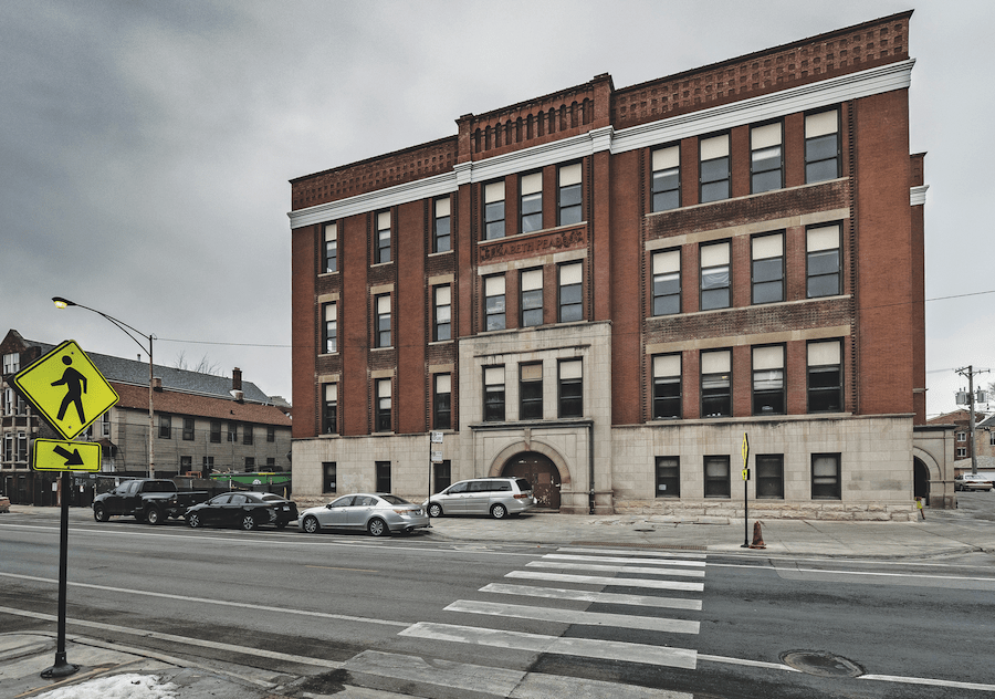 Exterior of Peabody School Apartments, an adaptive reuse project in Chicago and 2023 BALA winner, before renovation