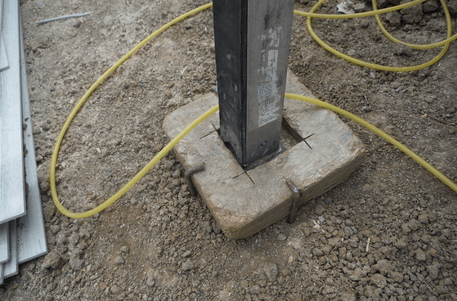Ladder safety for pump jacks includes a secure base plate