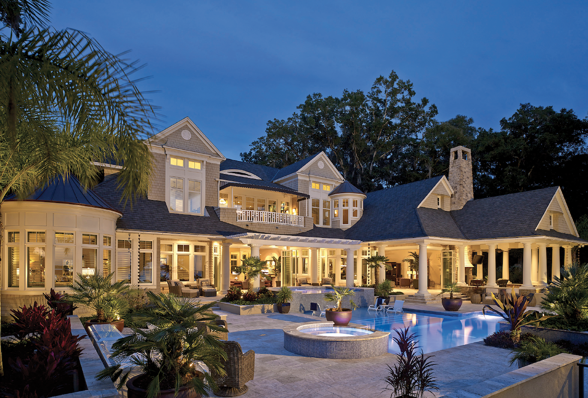 outdoor living space and exterior view of the luxury custom home at Senator's Bluff designed by The Evans Group