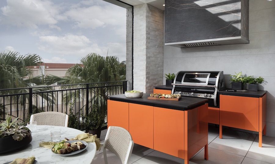 Brightly colored outdoor kitchen cabinets from Brown Jordan in The New American Home 2021