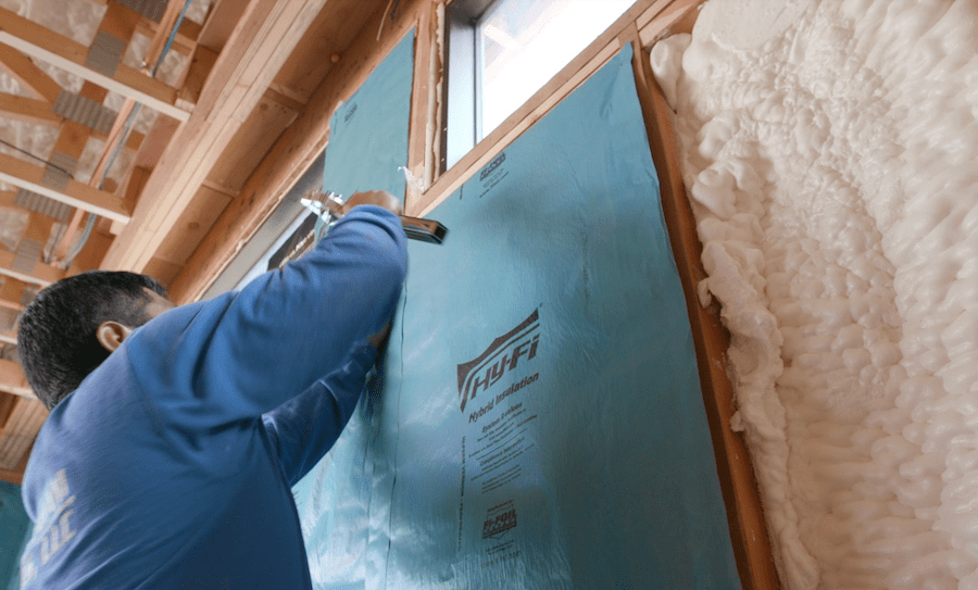 Installing insulation in The New American Home 2023, a high-performance, energy-efficient home