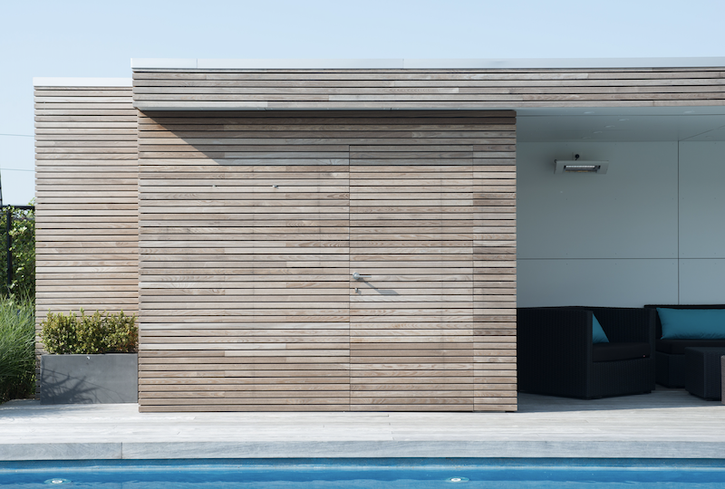 Thermory PaCS press-and-click-wood siding exterior by pool