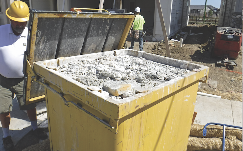 steel bin on construction site for collecting paint and plaster slurry
