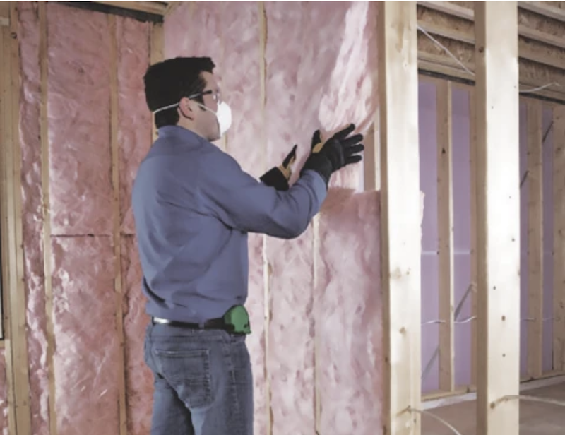 Installing fiberglass batt insulation in walls